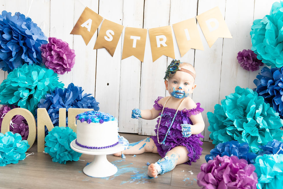 baby girl getting messy with cake smash