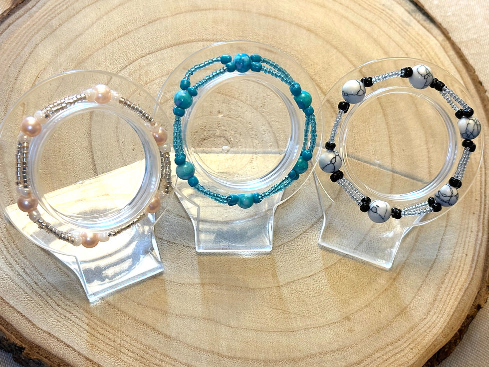 Thumbnail: View of 3 bracelets, one is peach pearls, turquoise glass beads, white/black large marbled beads