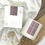 Thumbnail: A white candle jar with purple label + white candle box with purple branding.