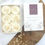 Thumbnail: 6 round shaped botanical wax melts with cream dried botanicals on top in a luxury match style box.
