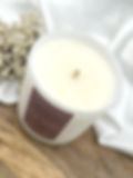A Tom Ford dupe candle of rose prick, in a white matte vessel with purple label.
