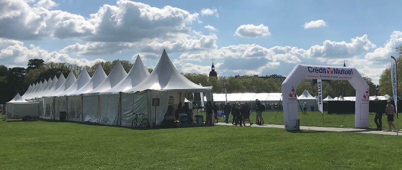 A landscape picture of the gazebo's set up on the Paquier on pre-race day for marathon Annecy.