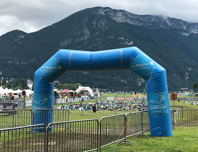 A blow up arch shows where triathletes recuperate their stuff on the Paquier in Annecy.
