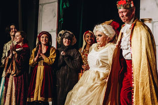Cast of Sleeping Beauty smiling onstage