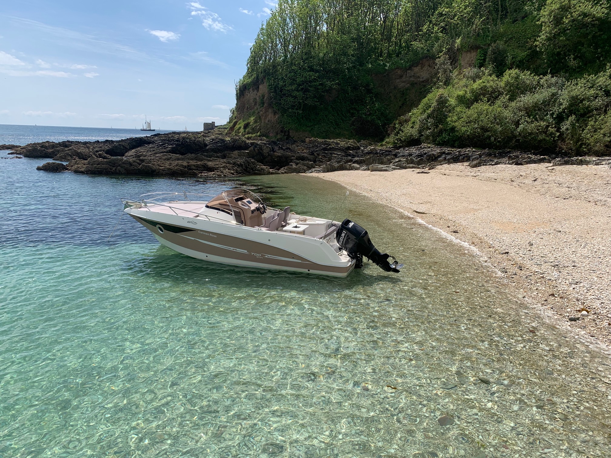 Carmen Rose anchored in clear bay water