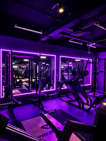 Functional fitness and workout area at Prime Fitness Meydan with premium equipment, mirrors, and signature neon lighting.