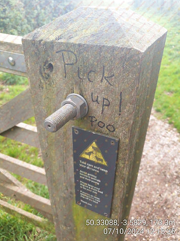 "Pick Up Poo" Graffiti On A Wooden Post