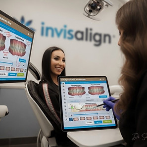 Dr Sayeh Hadianfar Cosmetic Dentist and Invisalign provider giving consult at Spinel Dental Hamilton invisalign consult and using digital scanner iTero and reviewing ClinCheck of the patient