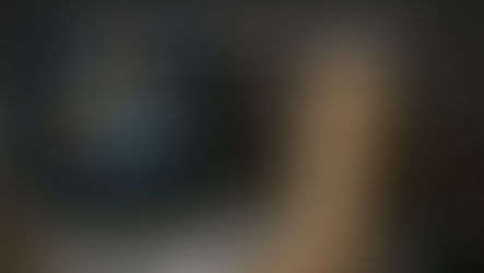 A laptop displaying martech app icons sits beside a wobbly Jenga-style wooden tower and a calculator, illustrating martech optimization and ROI challenges.