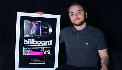 Kyle Burkett with one of his Billboard Plaques