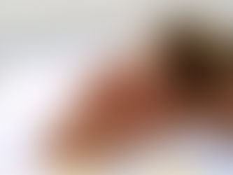 Woman receiving massage at Airbnb, white towels, smiling at partner