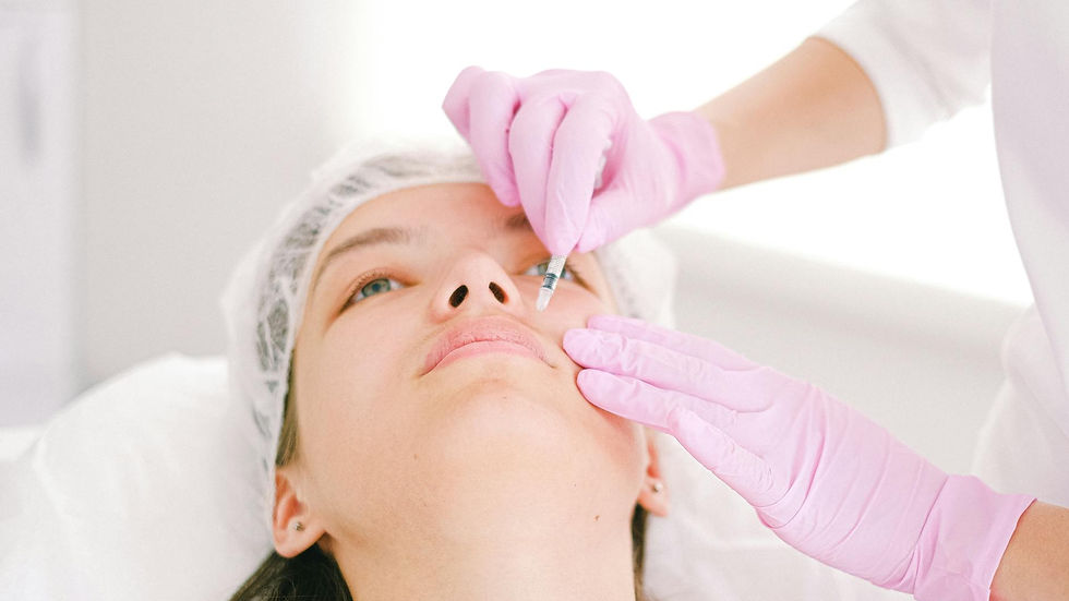 Woman receiving a facial cosmetic injection in a professional clinic setting.