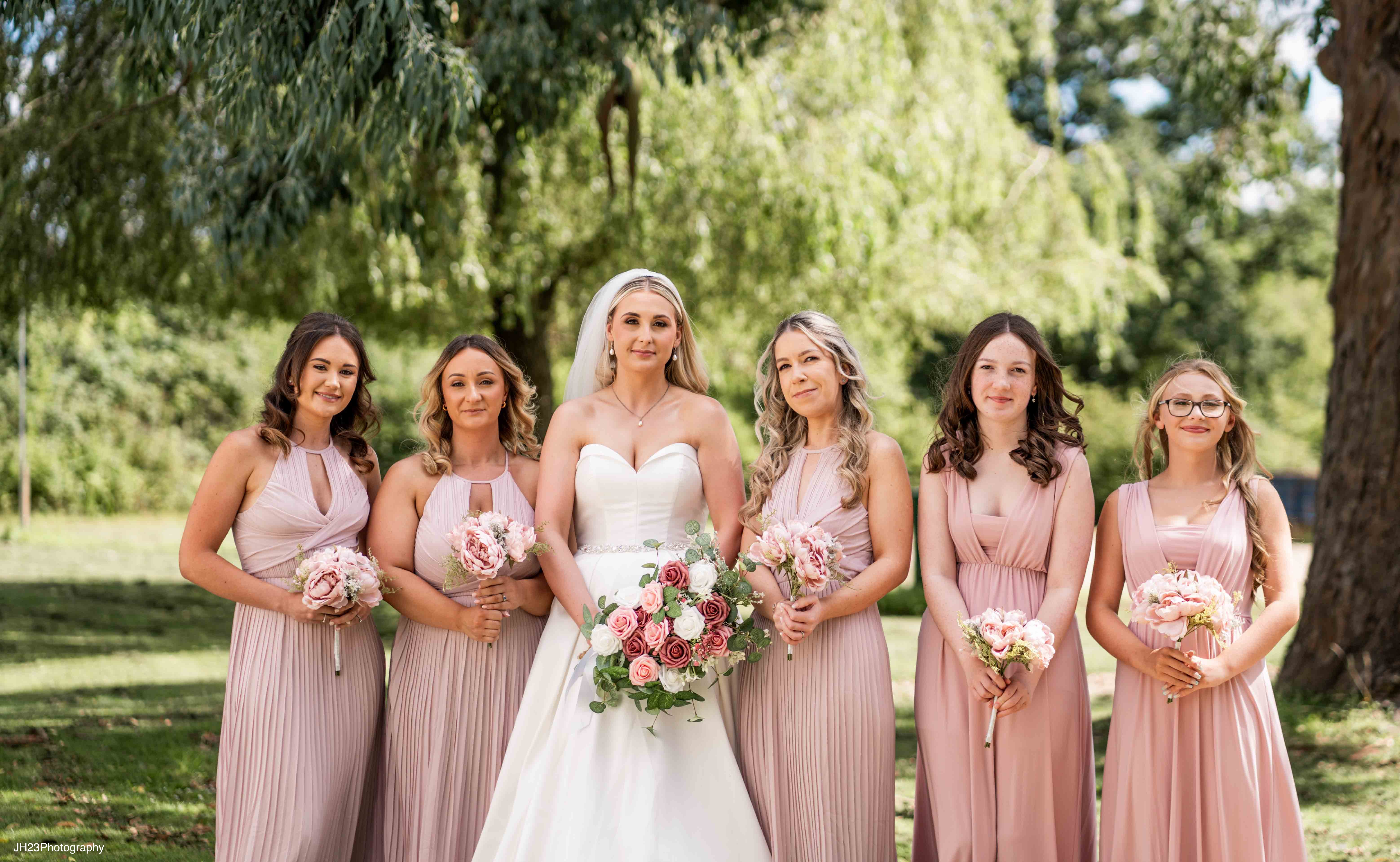 Bride and bridesmaids in blush pink dresses