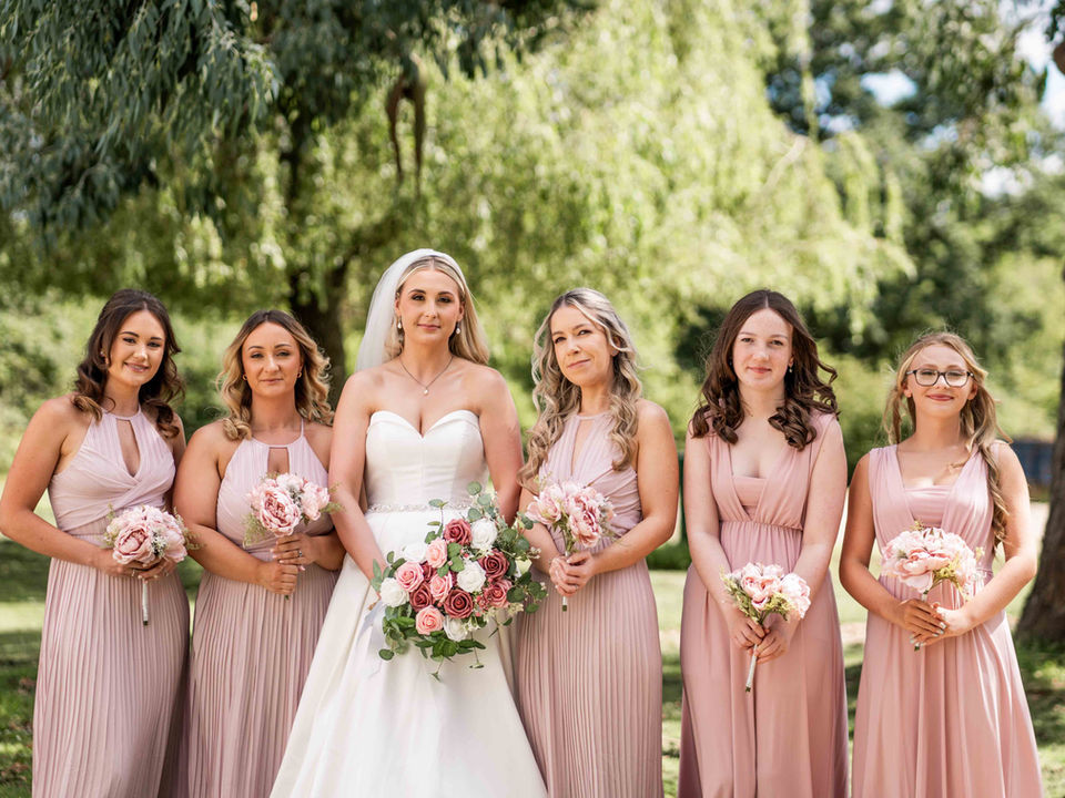 Bride with bridesmaids in blush pink dresses