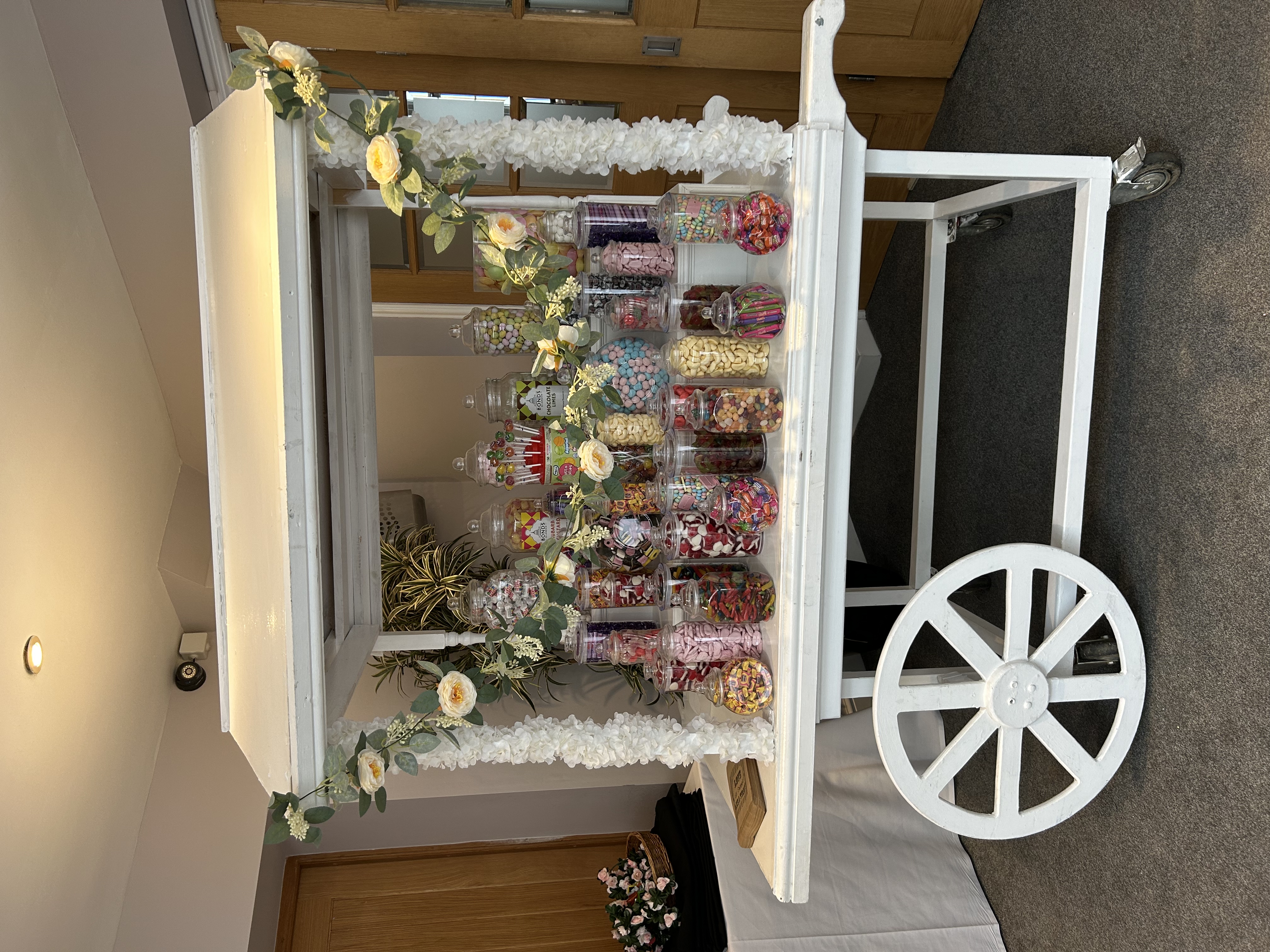 White candy cart filled with sweets