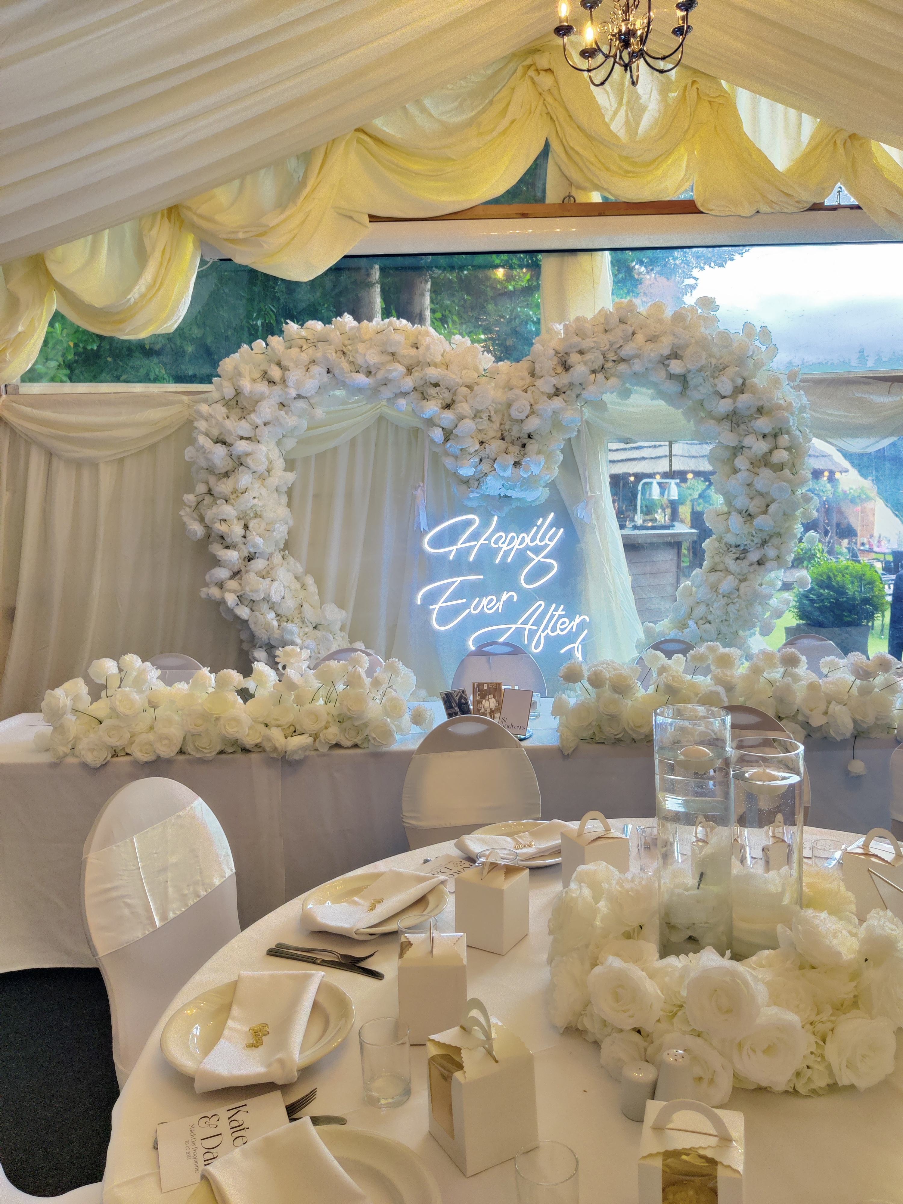 Wedding reception backdrop: double heart floral arch with Happy Ever After neon sign
