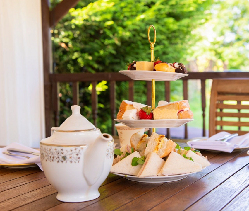 Afternoon tea: sandwiches, cakes, teapot