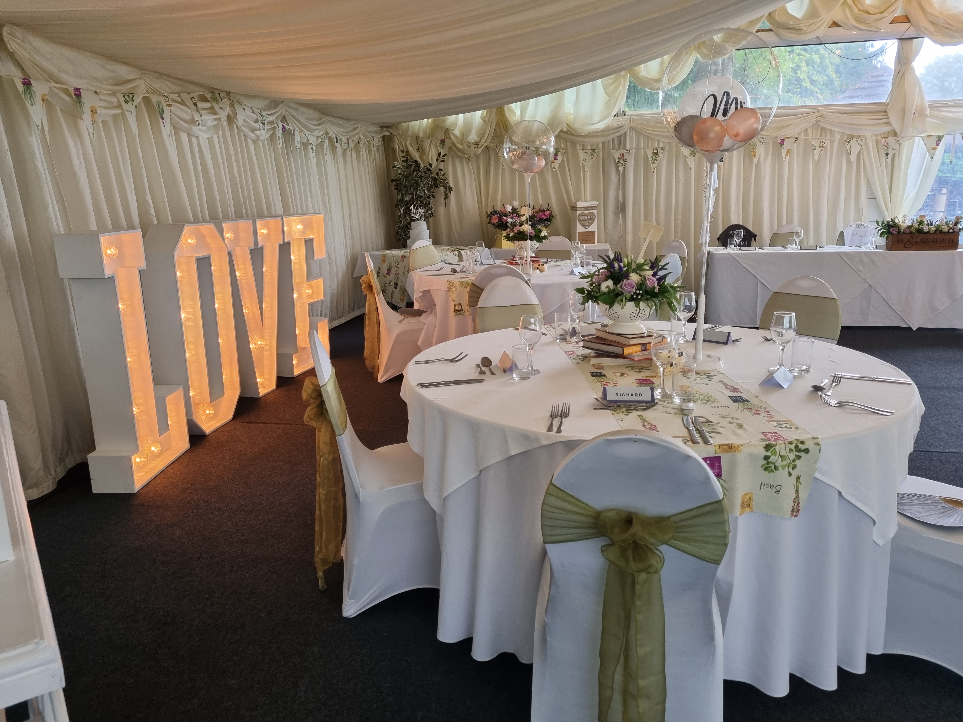 Illuminated LOVE letters at wedding reception