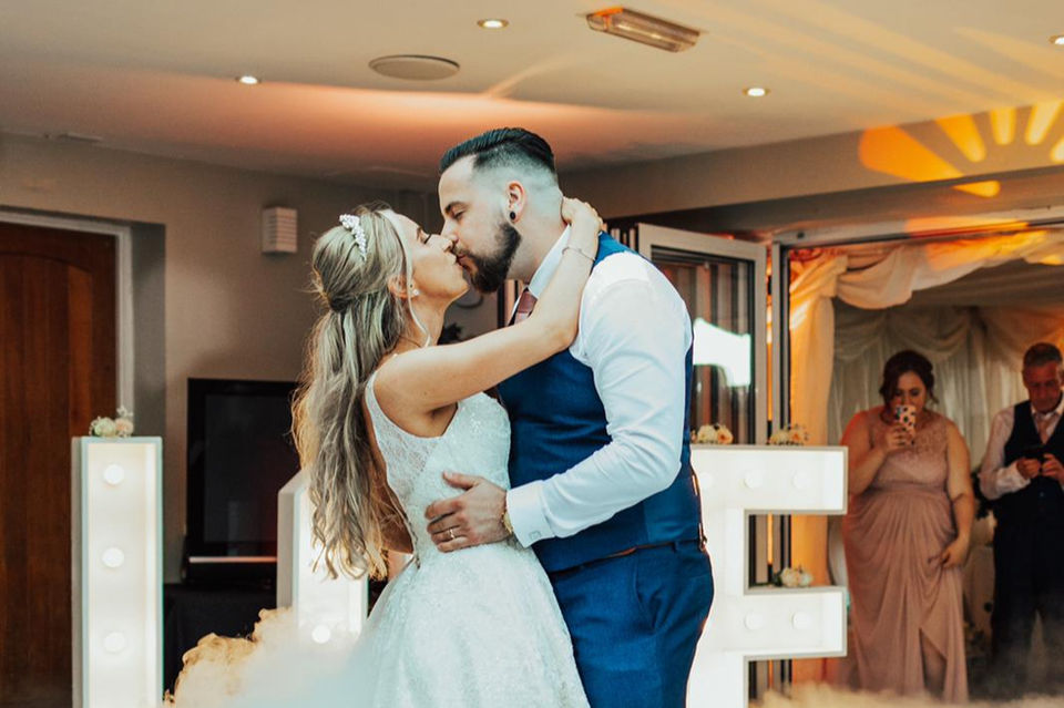 Bride and groom sharing a kiss at their wedding reception