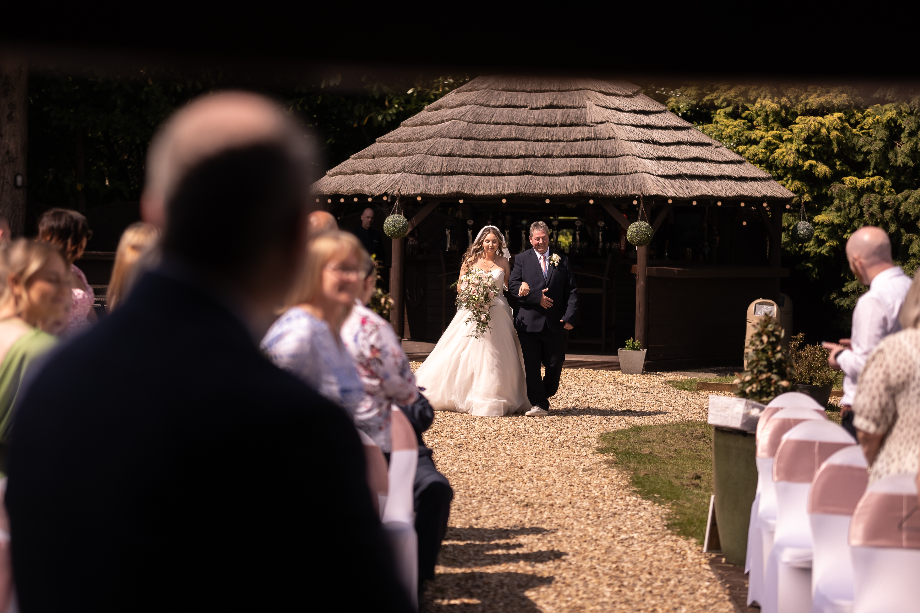 Bride walking down aisle with father
