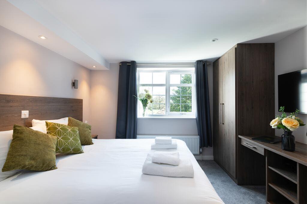 Spacious hotel room with a comfortable double bed
