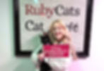 Roo is adopted as his new family member holds a sign: It's a Purr-fect Match.