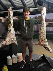 Will Lawler with Paper Mache Pig Carcasses
