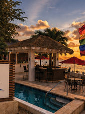 HöN Magazine editorial travel feature showcasing Sand Castle on the Beach in St. Croix, U.S. Virgin Islands, at sunset with a Pride flag overlooking the Caribbean Sea, celebrating island culture, LGBTQ+ inclusion, queer-owned hospitality, and the vibrant annual St. Croix Pride festivities.