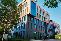 modern-office-building-with-green-trees-2025-03-28-12-31-09-utc