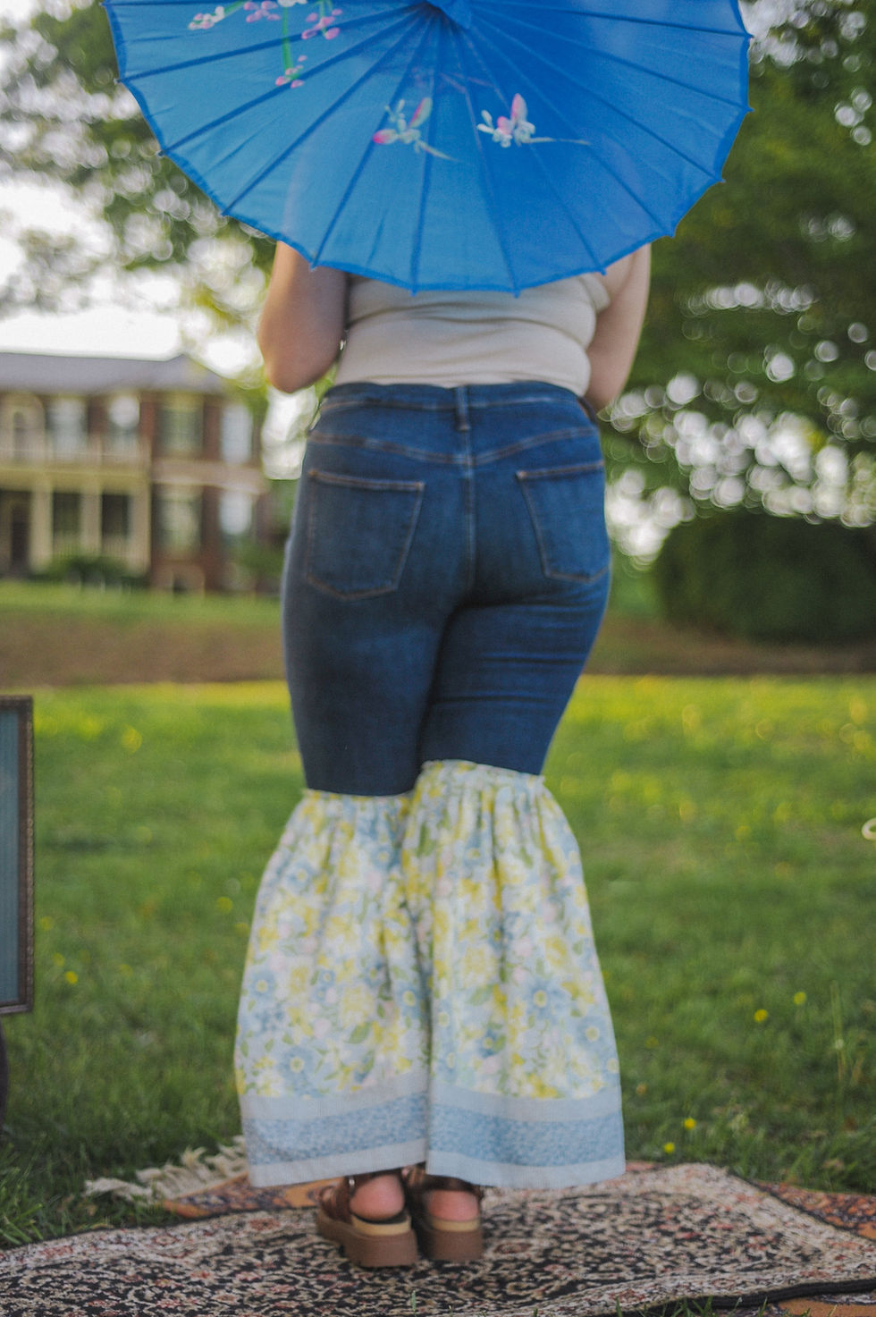 Thumbnail: Model wearing the Rosy Ruffle Bell Bottoms, showcasing the unique design made from repurposed curtains. The ruffled detailing