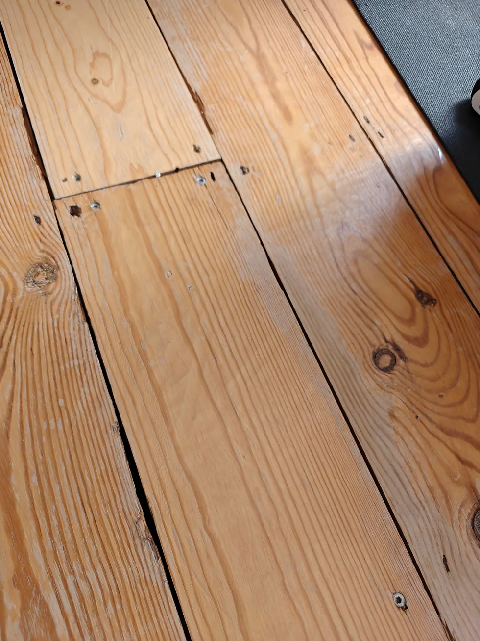 Scratches on a wooden floor from castor wheels.