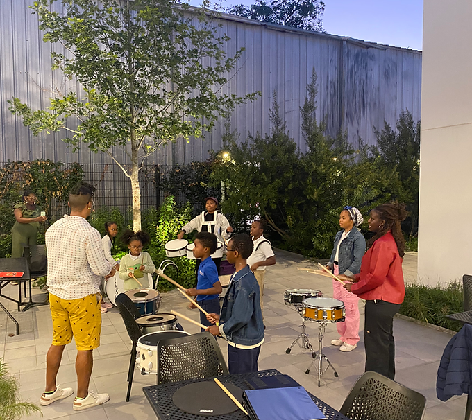Students Learning about the Drums in a court yard in Third ward houston texas