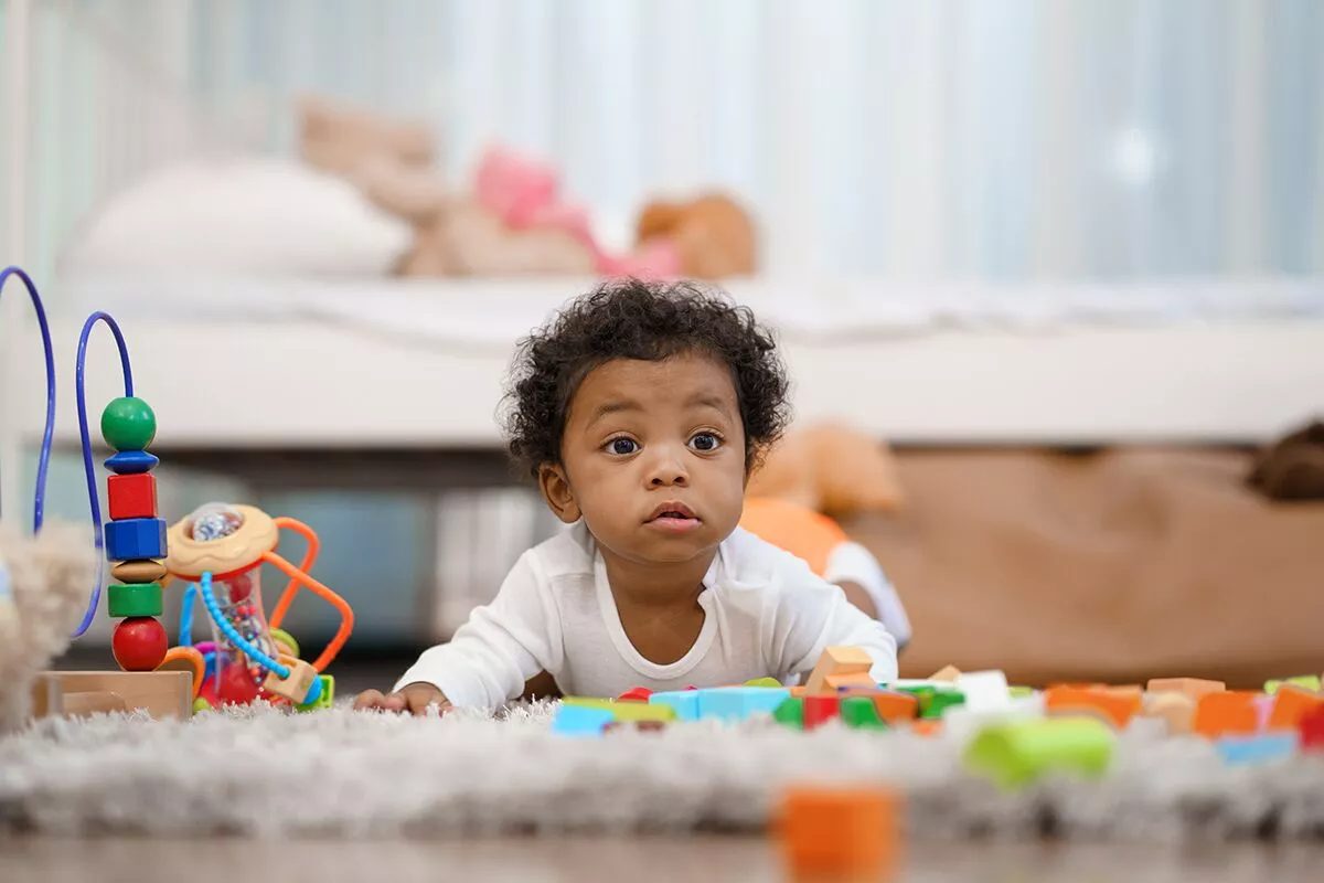 happy-african-american-little-baby-boy-crawling-looking-some-thing-learn.webp