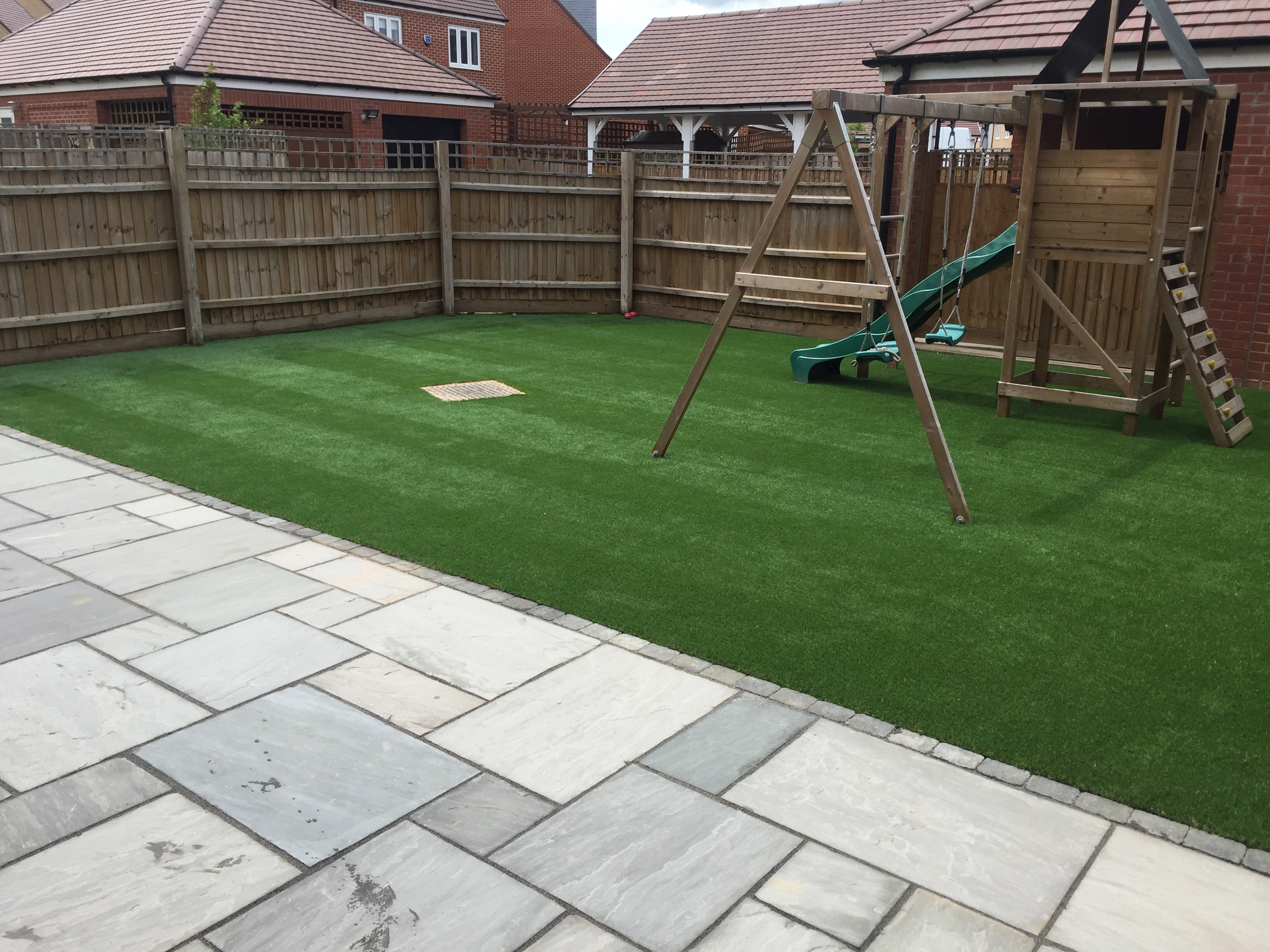 Sandstone patio and artificial lawn