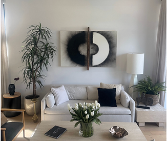 Design forward living room with striking artwork, beautiful faux tullips and other modern decor in an Arcadia home.