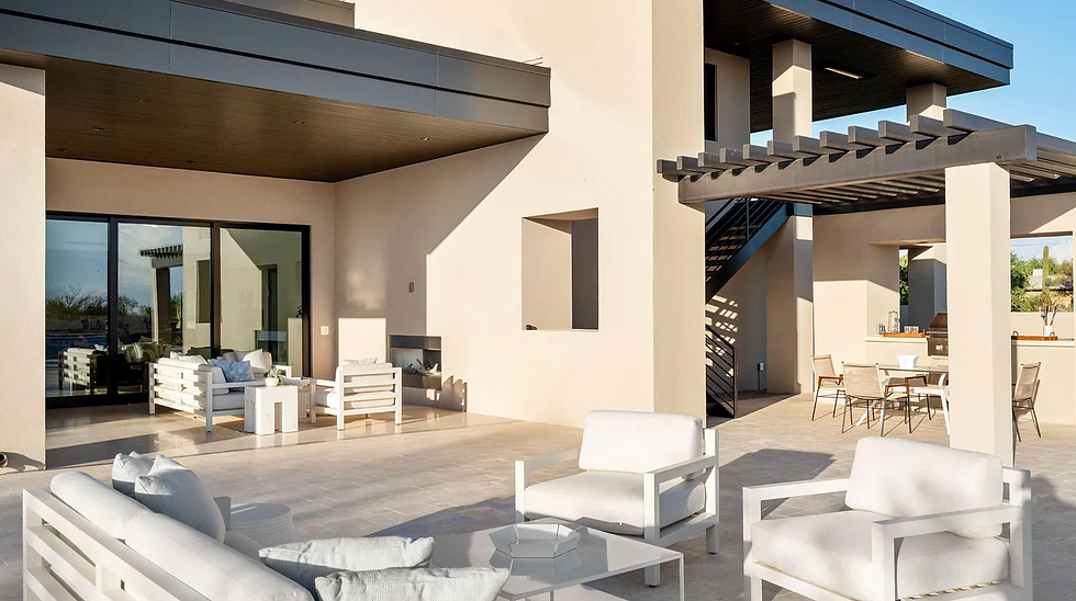 Outdoor patio staged with various seating and sun lounging vignettes with outdoor furnishings.