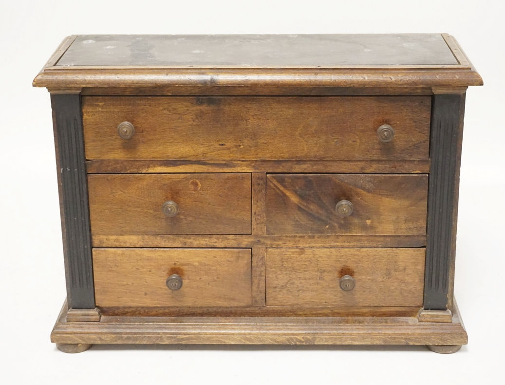 5 DRAWER CABINET IN MIXED WOODS WITH EBONIZED COLUNMS AND AN INSET SLATE TOP. 16