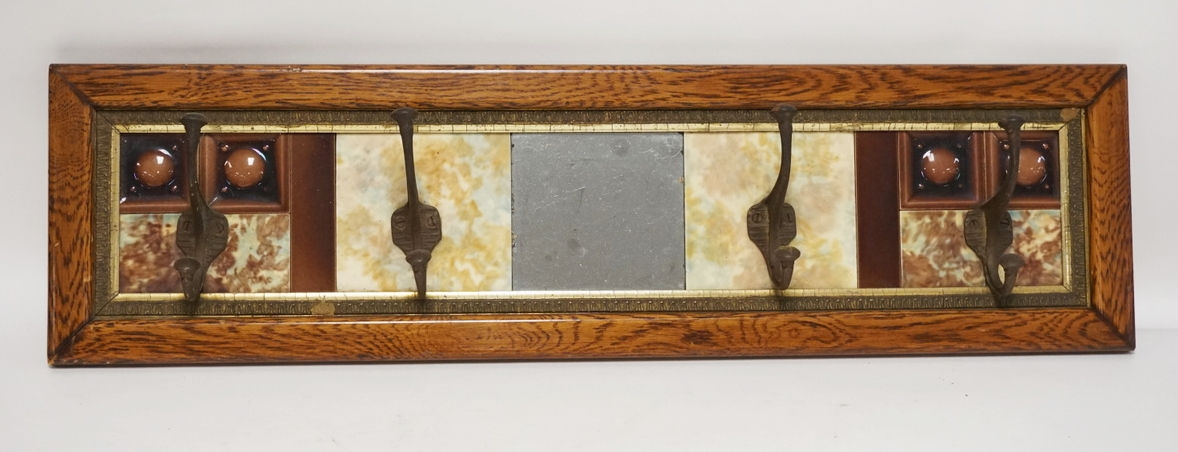HAT RACK WITH AN OAK FRAME, TILES, AND A MIRRORED CENTER. 37 X 10 INCHES.