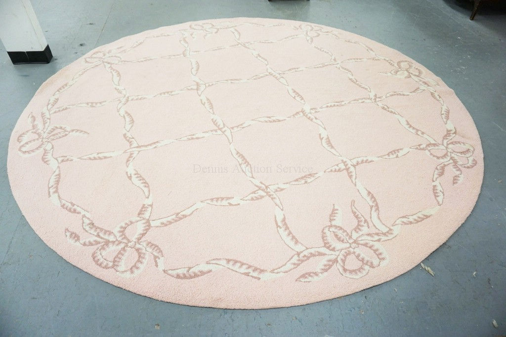 ROUND HOOKED RUG IN PINK WITH CREAM COLORED RIBBON DECORATION. 9 FT 7 INCH DIA.