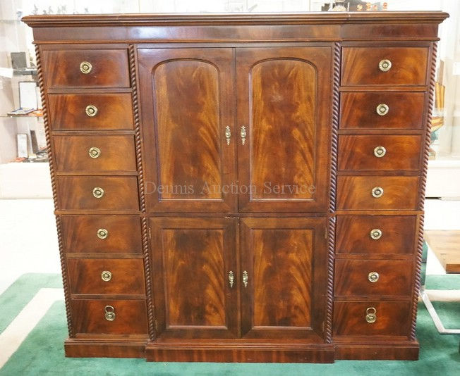 MAHOGANY ENTERTAINMENT CABINET WITH PANELED DOORS AND BRASS HARDWARE.