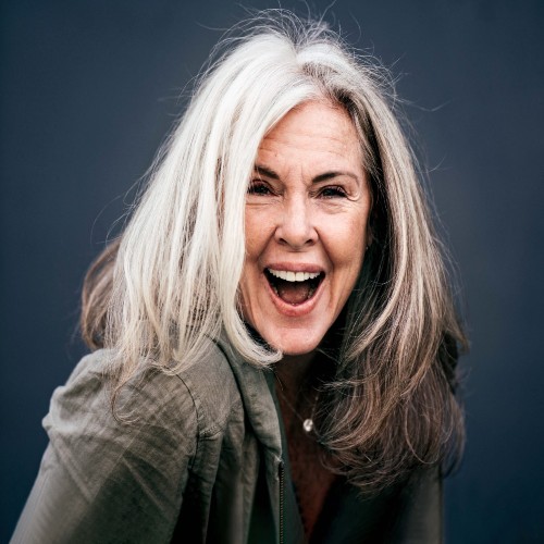 Happy woman embracing her white hair