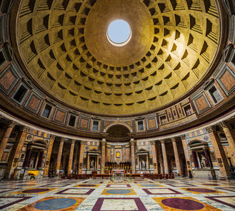 Interior of the Pantheon in Rome, Italy, featuring the massive coffered dome, central oculus, marble columns, and colorful marble floor beneath one of the world's most iconic ancient buildings.