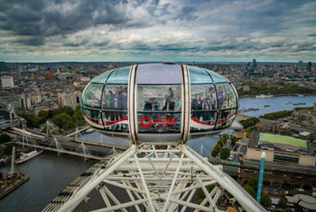 Close-up of a London Eye observation capsule overlooking the River Thames and the London skyline, photographed from the wheel in London, England.