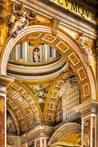 Intricate gilded arches inside St. Peter's Basilica in Vatican City, featuring ornate Renaissance architecture, decorative coffers, and richly detailed architectural elements.