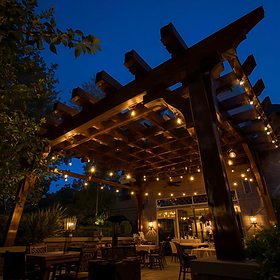 professionally installed bistro lighting beneath a high end wood pergola 2.png