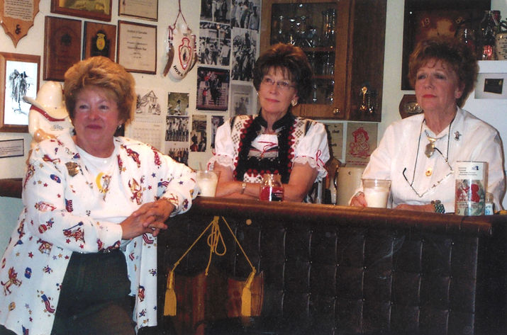 Three women at bar, awards on wall