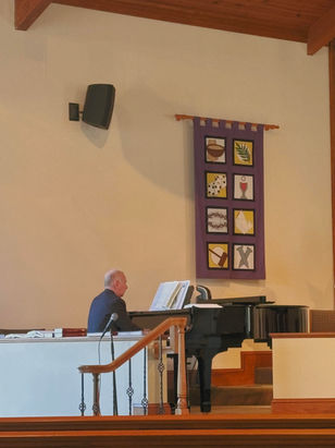 pianist playing music with banner in background
