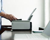 Man Using Computer Printer