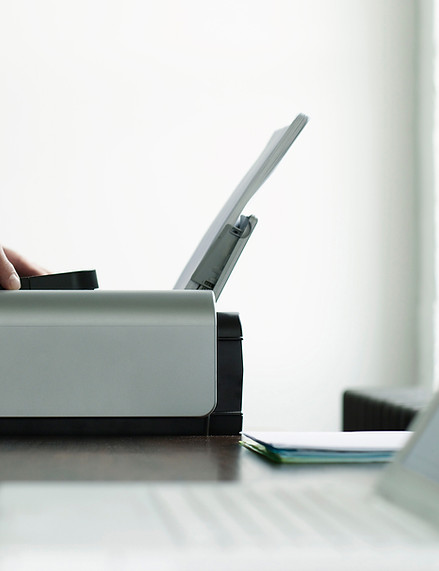 Man Using Computer Printer