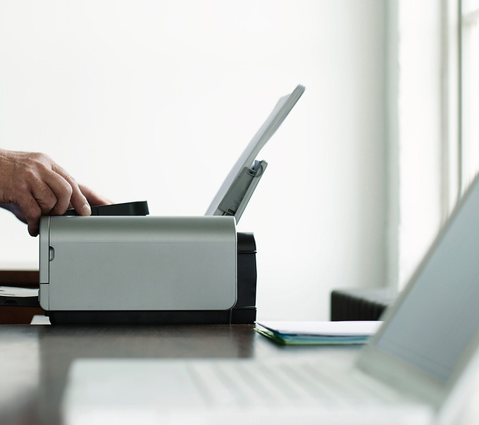 Man Using Computer Printer